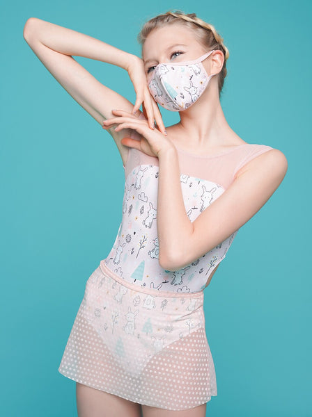 Model is wearing a pink Easter print leotard and pink polka dot mesh skirt with a matching Easter print fabric reusable face mask
