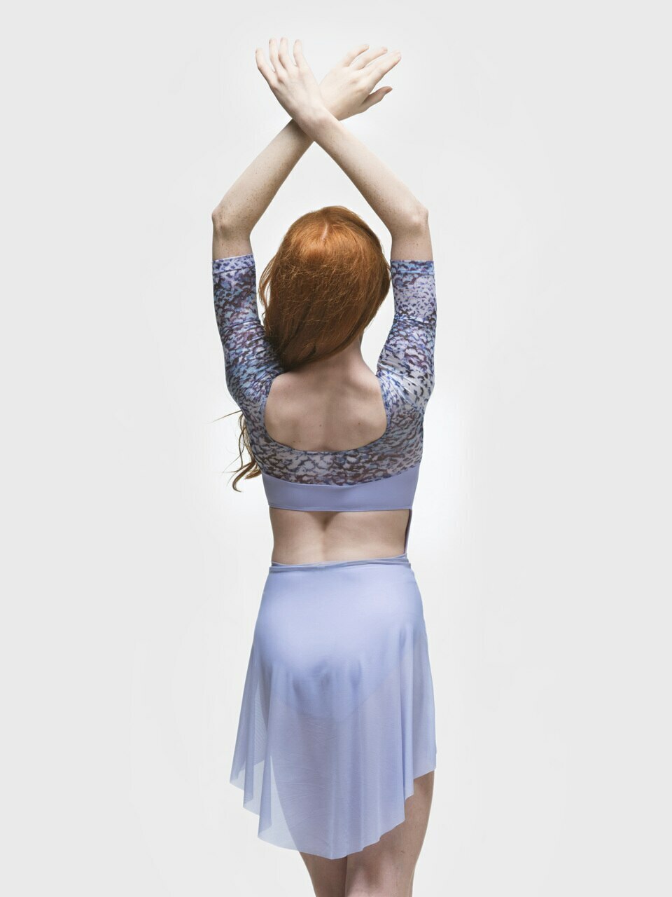 Eleve Dancewear Mid High-Low Skirt  Mesh in  Lavender color, back view of dancer posing with arms crossed above the head.