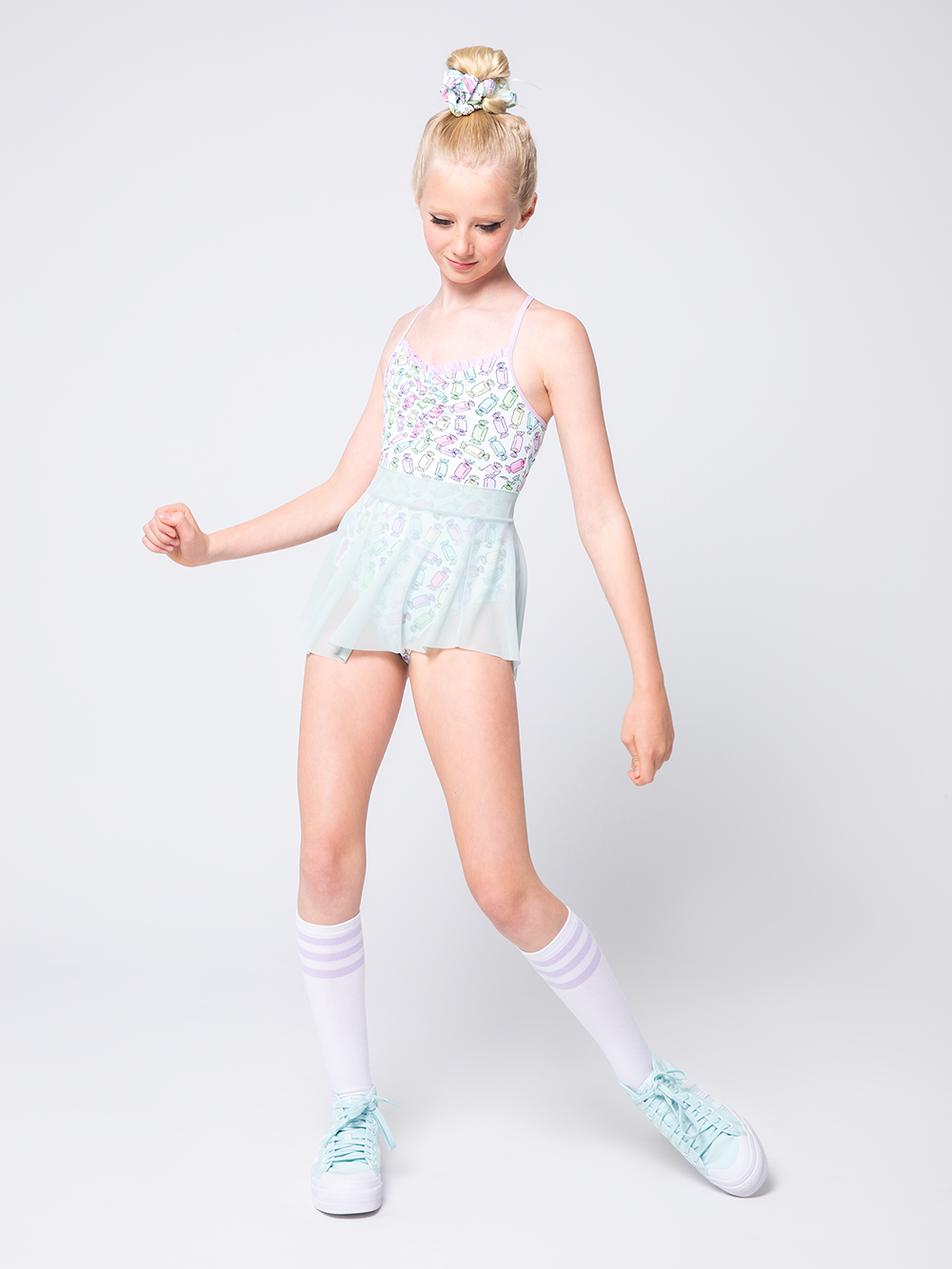 Model is in candy patterned leotard with sea glass mesh skirt