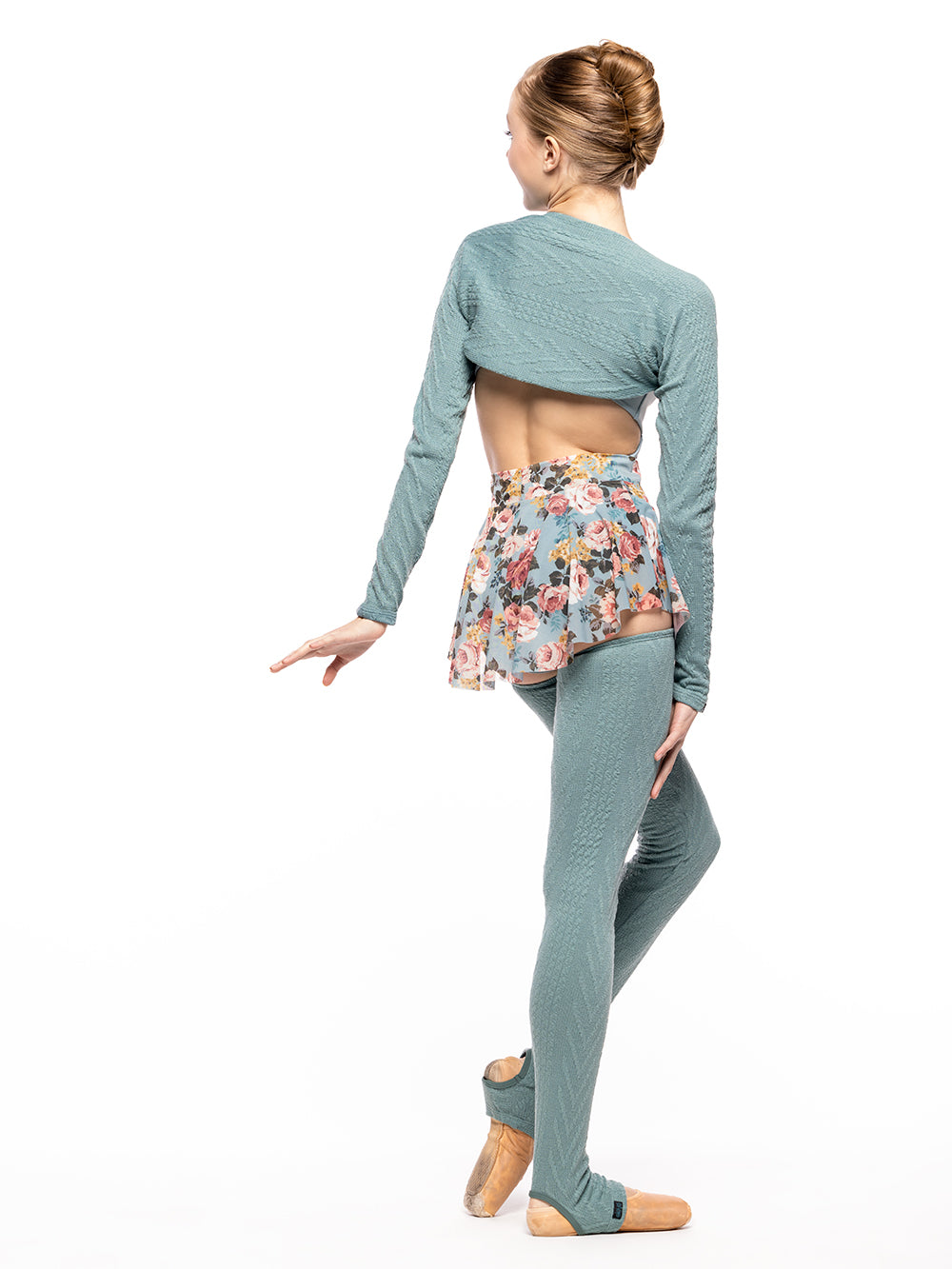 Back of model wearing Ocean blue green cable knit full length leg warmers matching Ocean knit shrug, light blue leotard with open back and light blue floral print mesh skirt