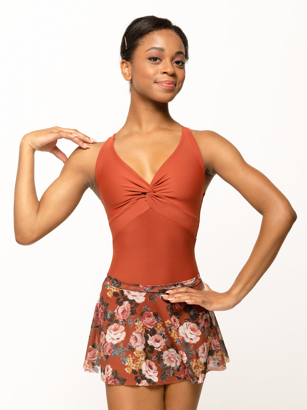 Model is wearing picante orange floral print mesh flare skirt with matching picante leotard