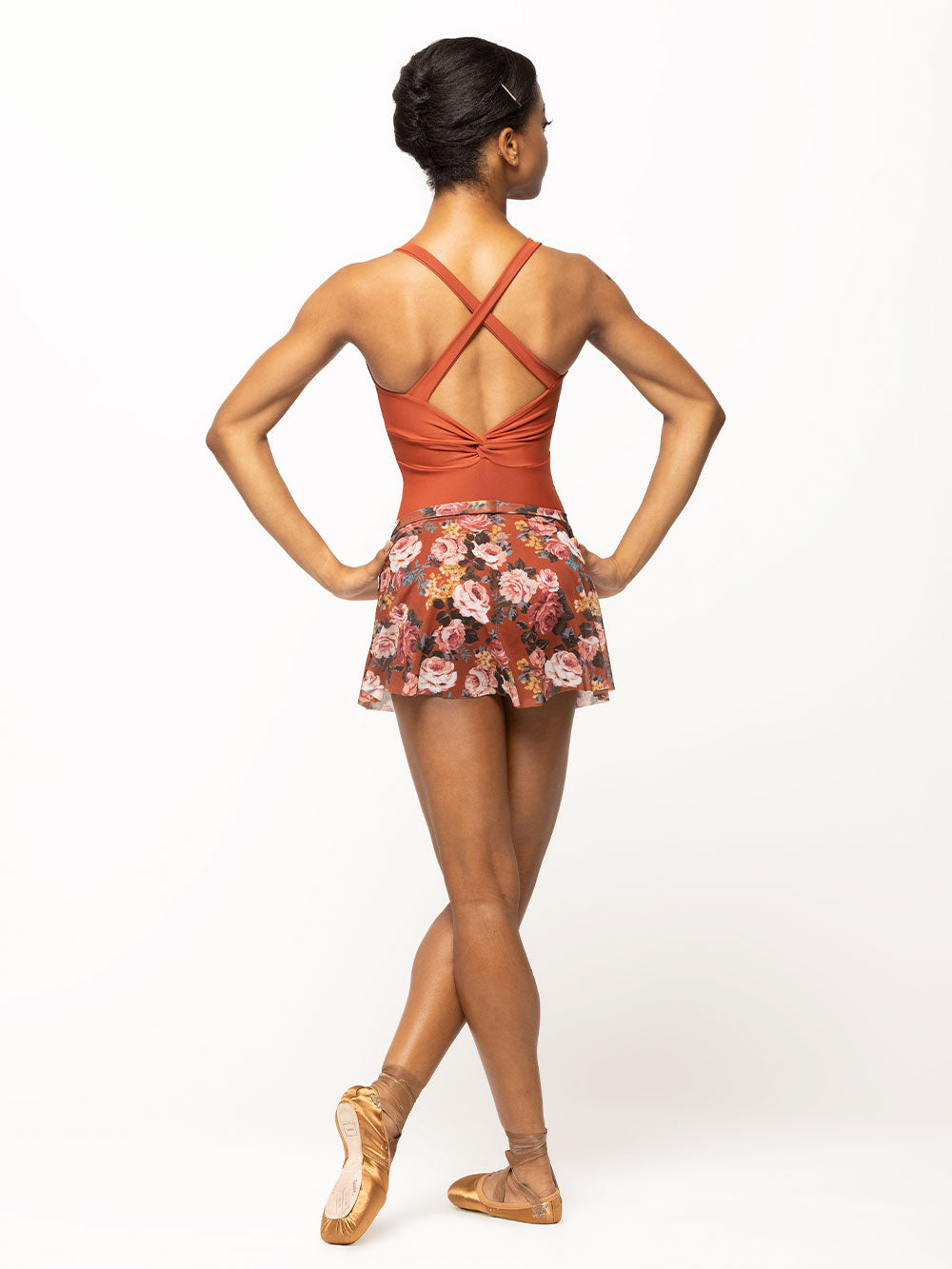 Back of model wearing picante orange floral print mesh flare skirt with matching picante leotard