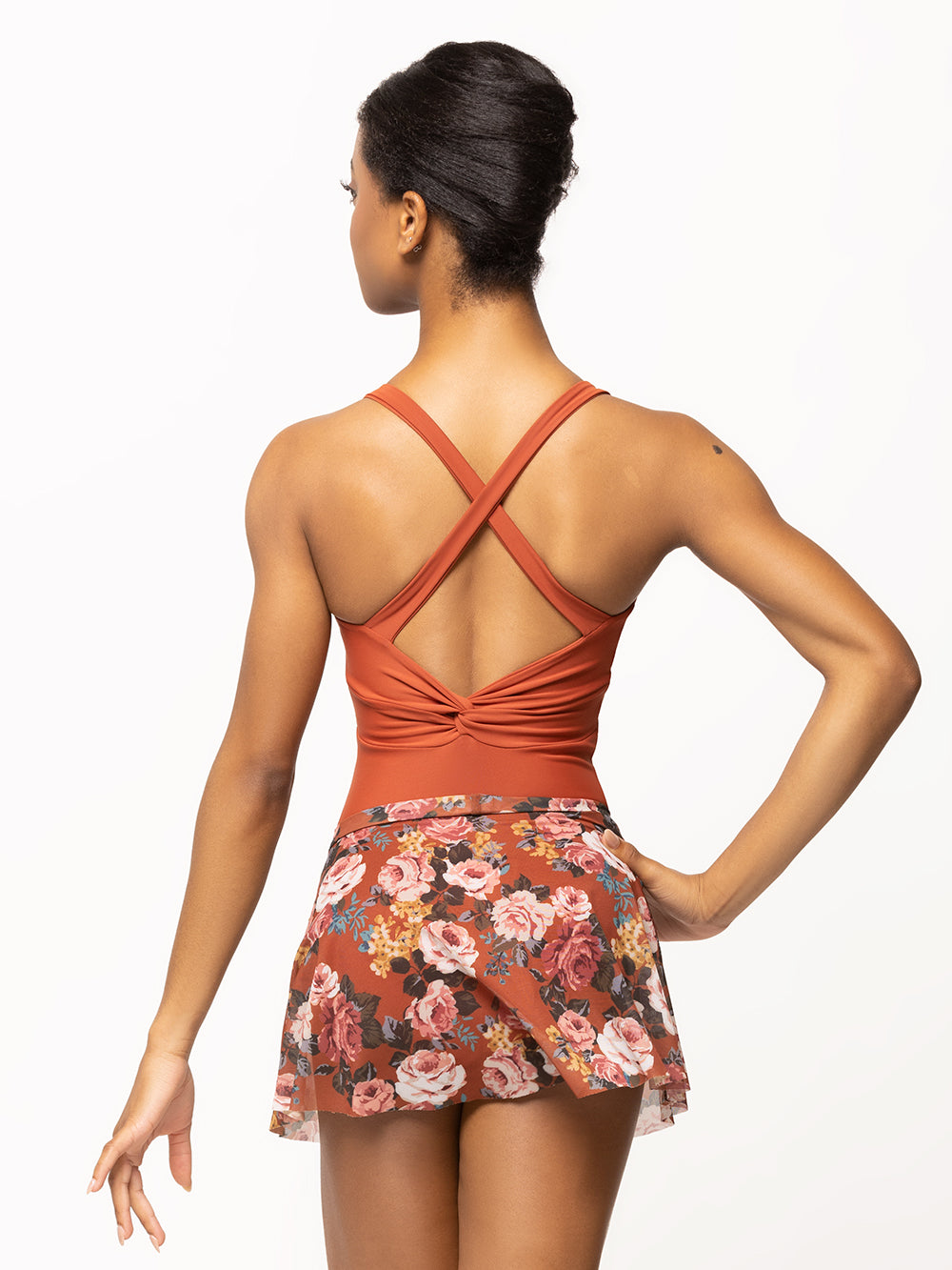 Back of model wearing picante orange floral print mesh flare skirt with matching picante leotard