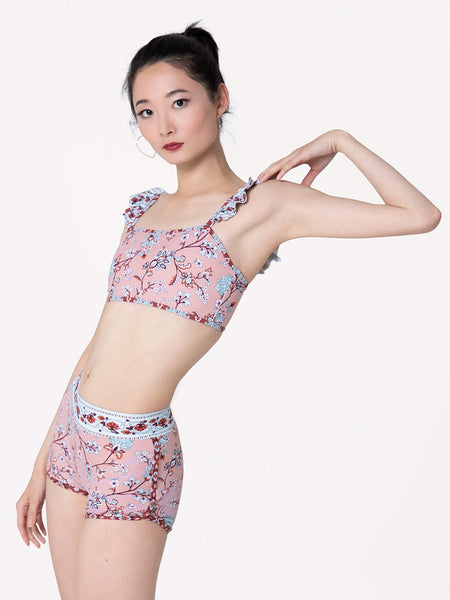 Model is in Pink floral pattern shorts with light blue waste band and matching crop top 