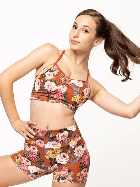 Model is wearing crop top in picante orange floral print with cami straps and pinch detail and matching bike shorts