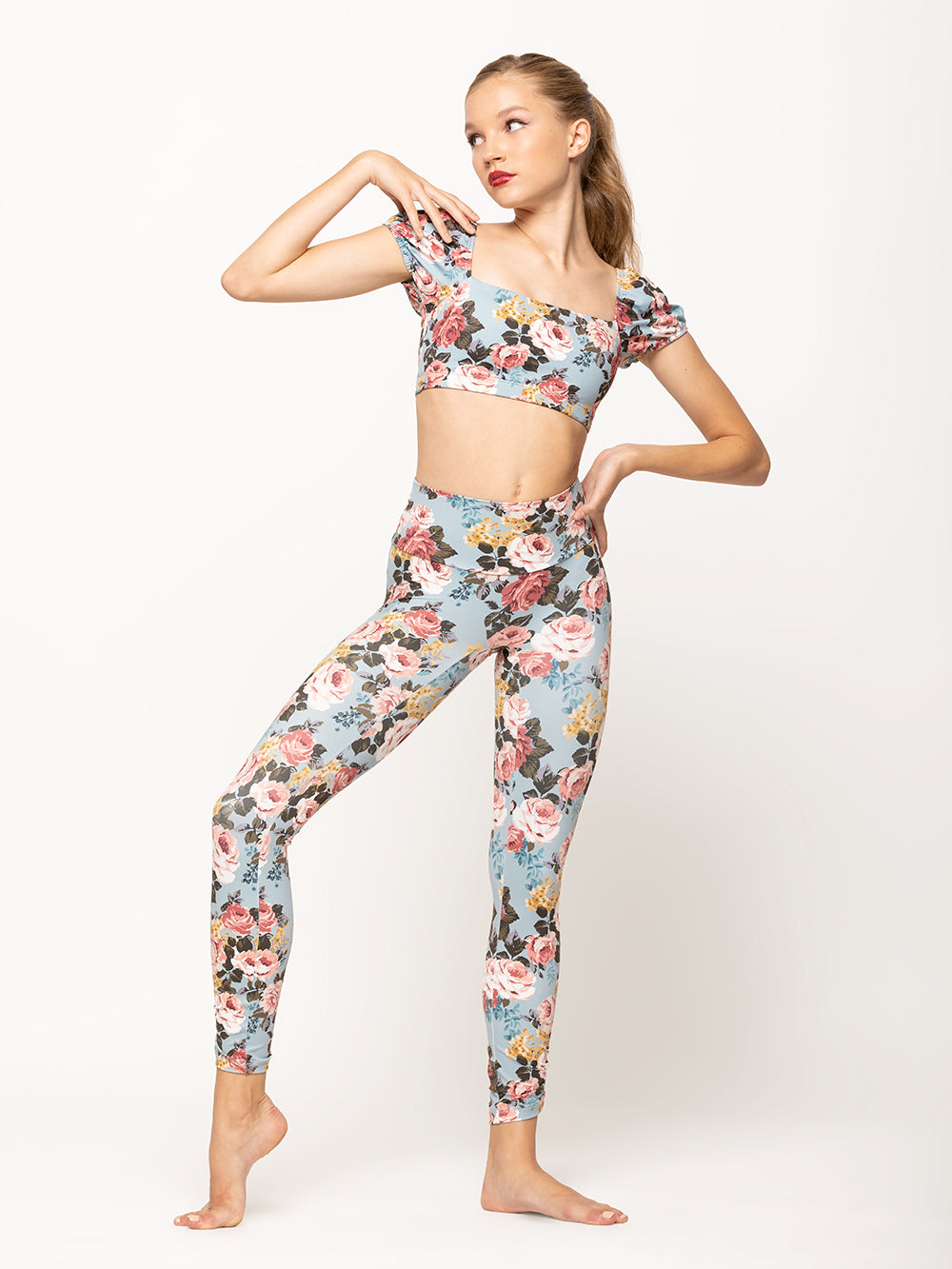 Model is wearing light blue floral pattern high waisted tights paired with matching crop top