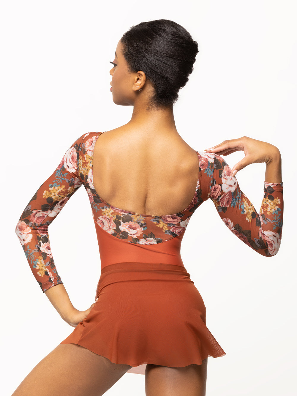 Back of model wearing picante orange leotard with matching orange floral print long mesh top, sleeves, and open back with matching orange mesh skirt