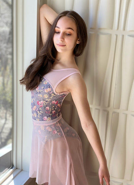 Model wearing a gray floral pattern leotard with pink mesh sleeves and a pink mesh skirt