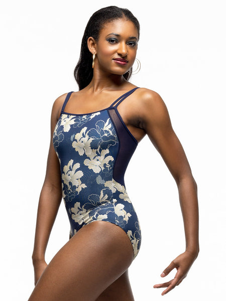 Model is wearing dark navy blue and gold floral print bodysuit with double cami straps and blue mesh back.