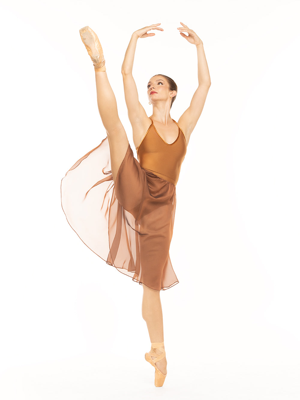 Eleve Dancewear Iris Leotard Kids in Cognac print color, front view of dancer posing on a la seconde on point.
