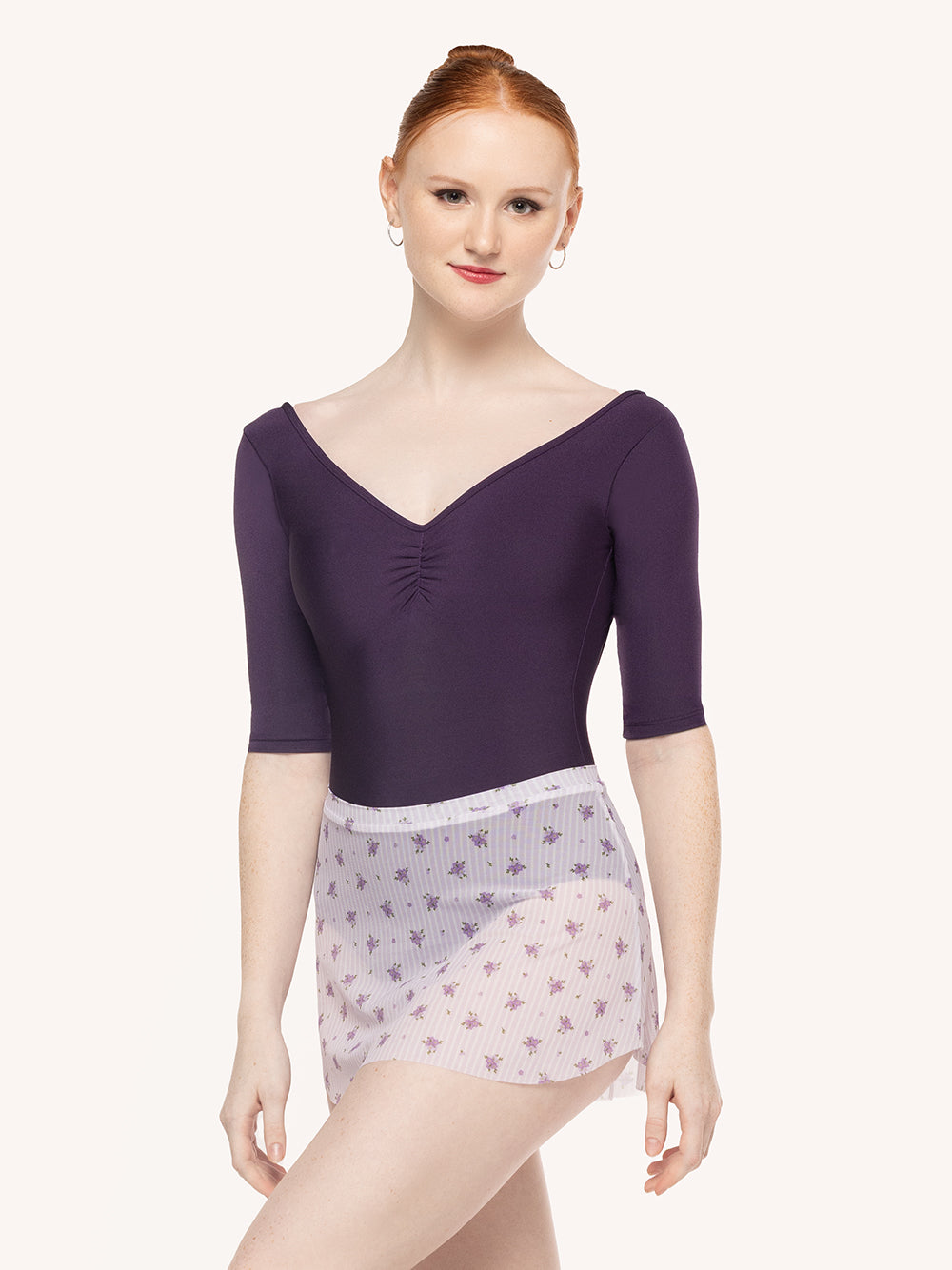 Eleve Dancewear Stella Leotard in Eggplant print color, front view of dancer posing.