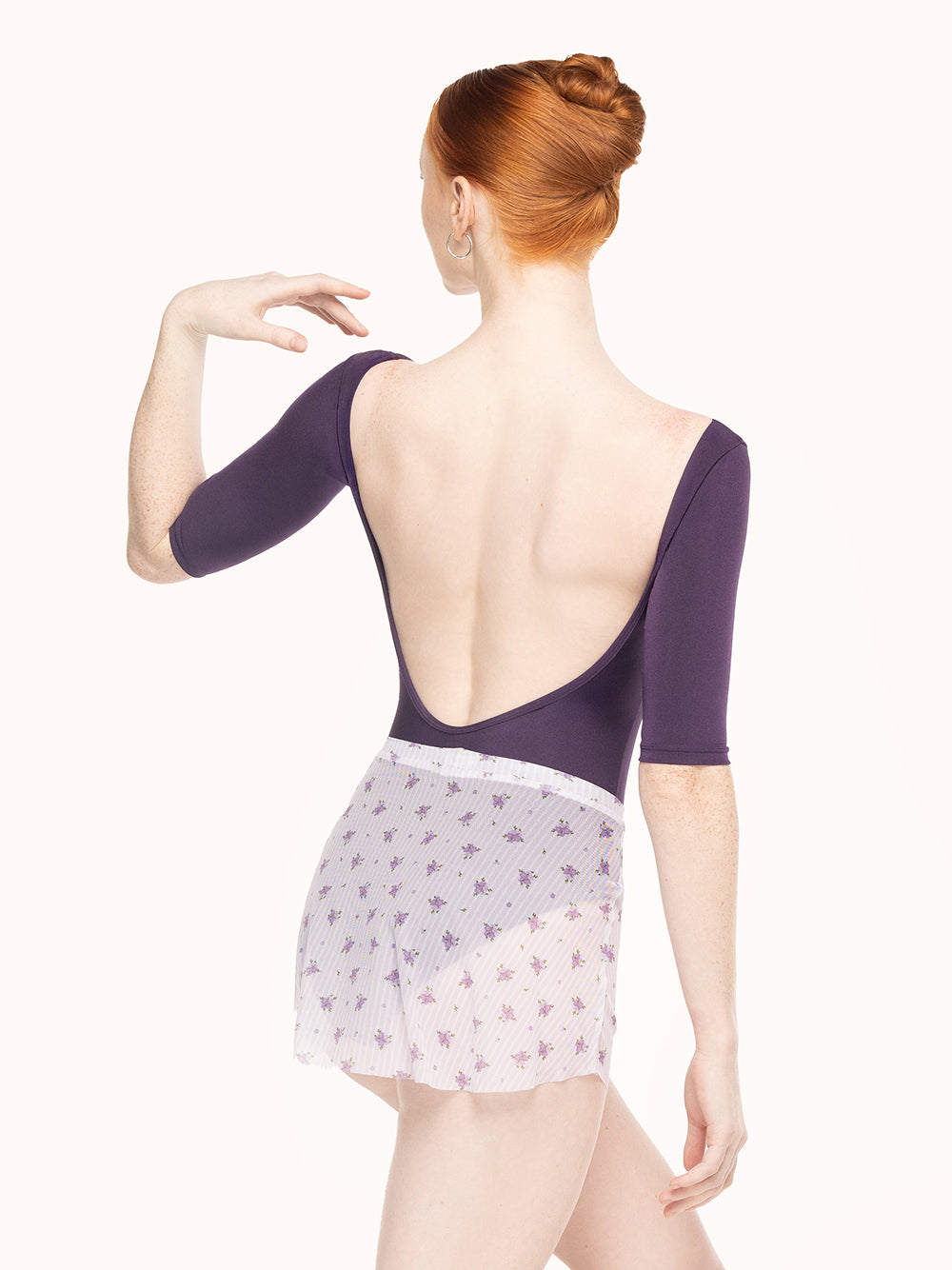 Eleve Dancewear Stella Leotard in Eggplant print color, back view of dancer posing.
