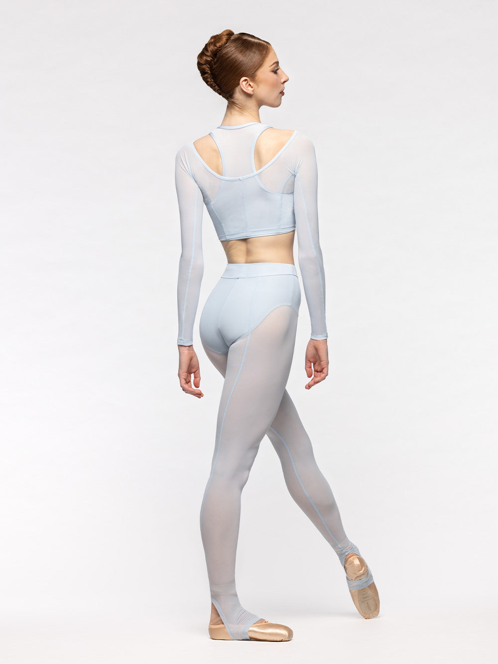 Eleve Dancewear Vivian Crop Top Kids in Frost print color, back view of dancer on tendu devant croise