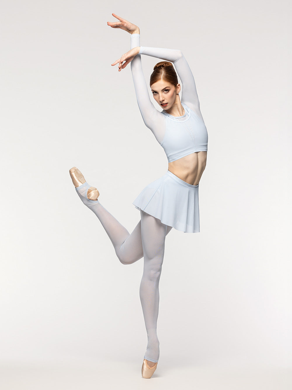 Eleve Dancewear Vivian Crop Top in Frost print color, front view of dancer on pique attitude en dedans