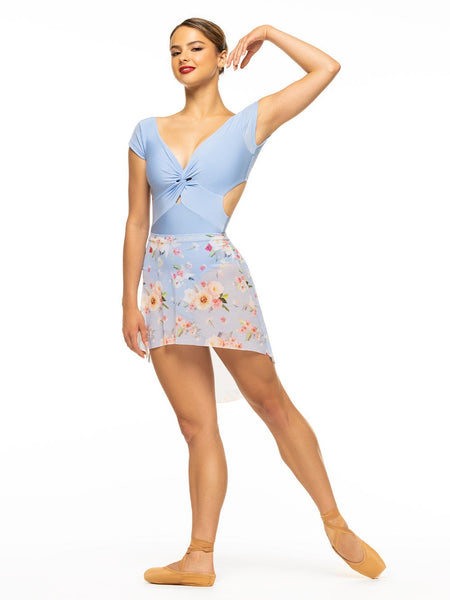 Model is wearing shiny baby blue bodysuit with a deep v, front twist, open back, and cap sleeves paired with blue floral print mesh high low skirt.