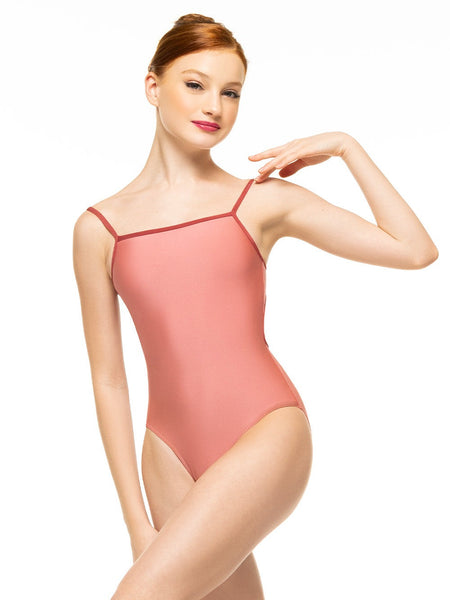 Model is wearing shiny pink bodysuit with rust trim and sporty open back.