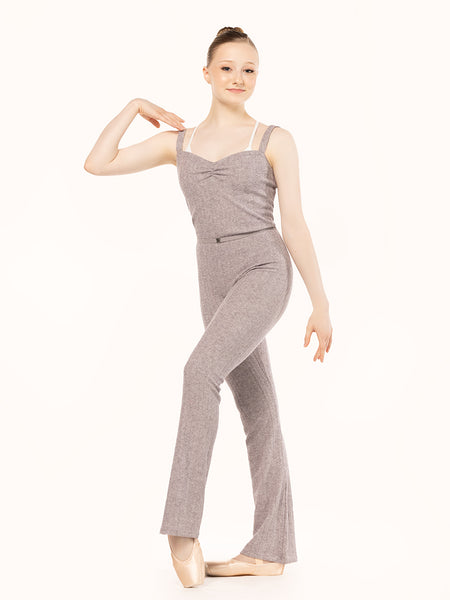 Model is wearing light brown knit long jumper with narrow shoulder straps and pinch front