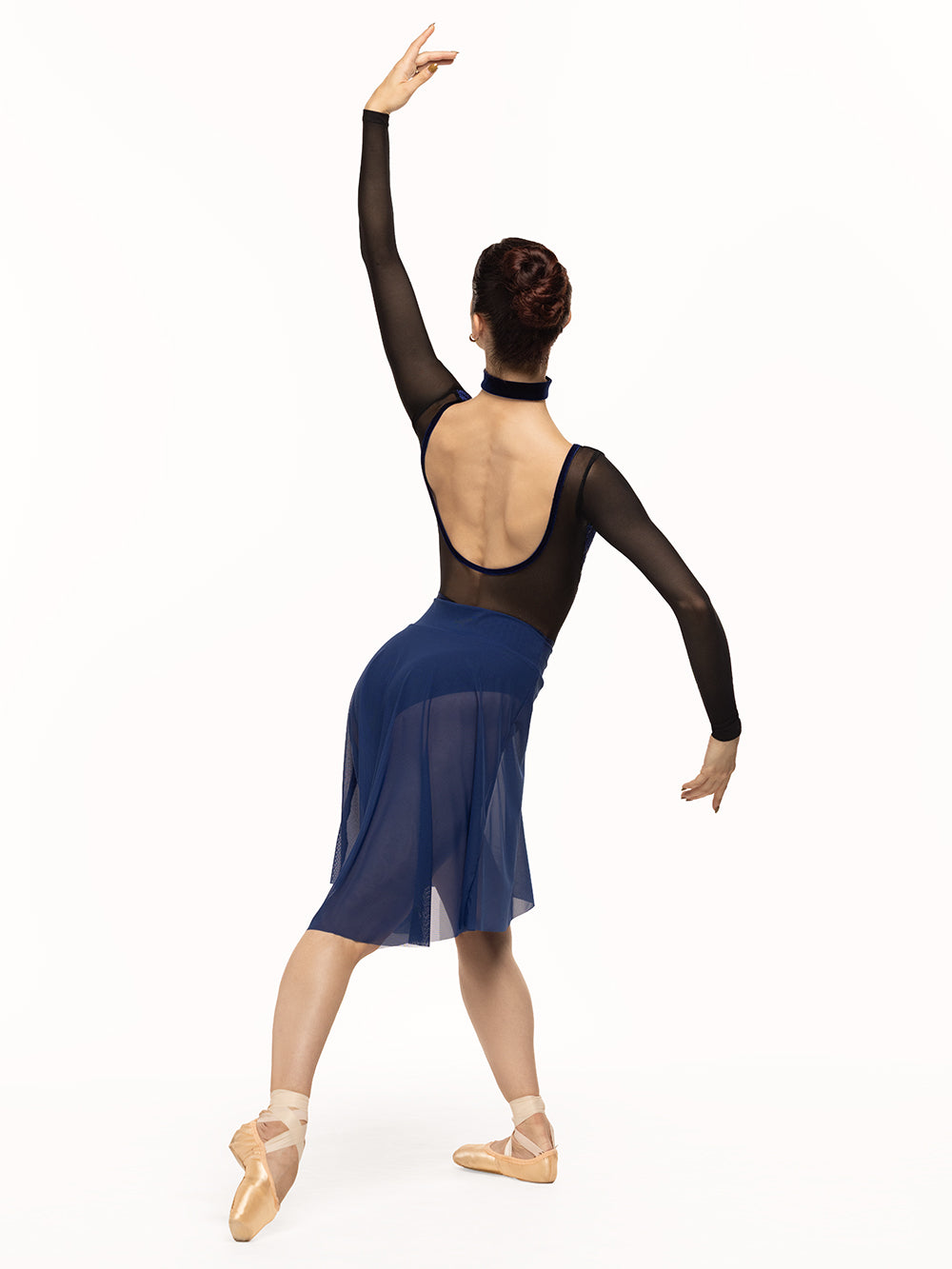 Eleve Dancewear Skylar Leotard in Baroque Sapphire color print, full body back view of dancer posing on tendu derriere croisé.