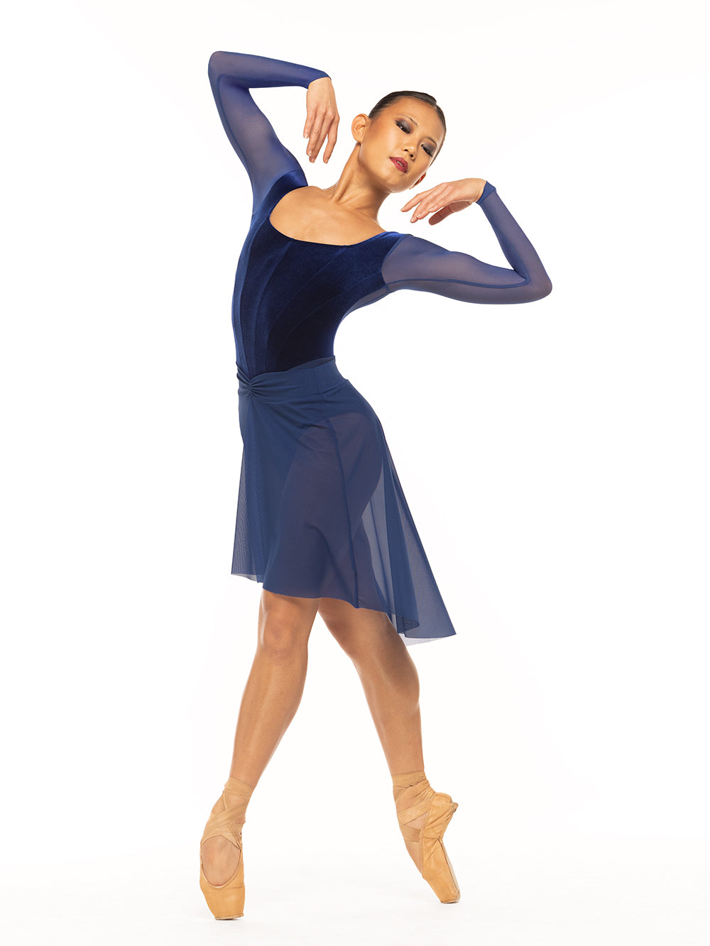 Eleve Dancewear Diana Leotard in Sapphire Velvet color, front view of dancer posing on four position on point.