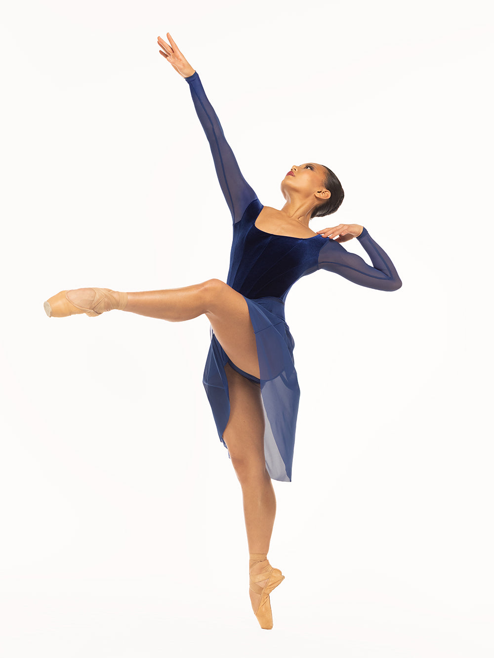 Eleve Dancewear Diana Leotard in Sapphire Velvet color, front view of dancer posing on attitude devant on point.