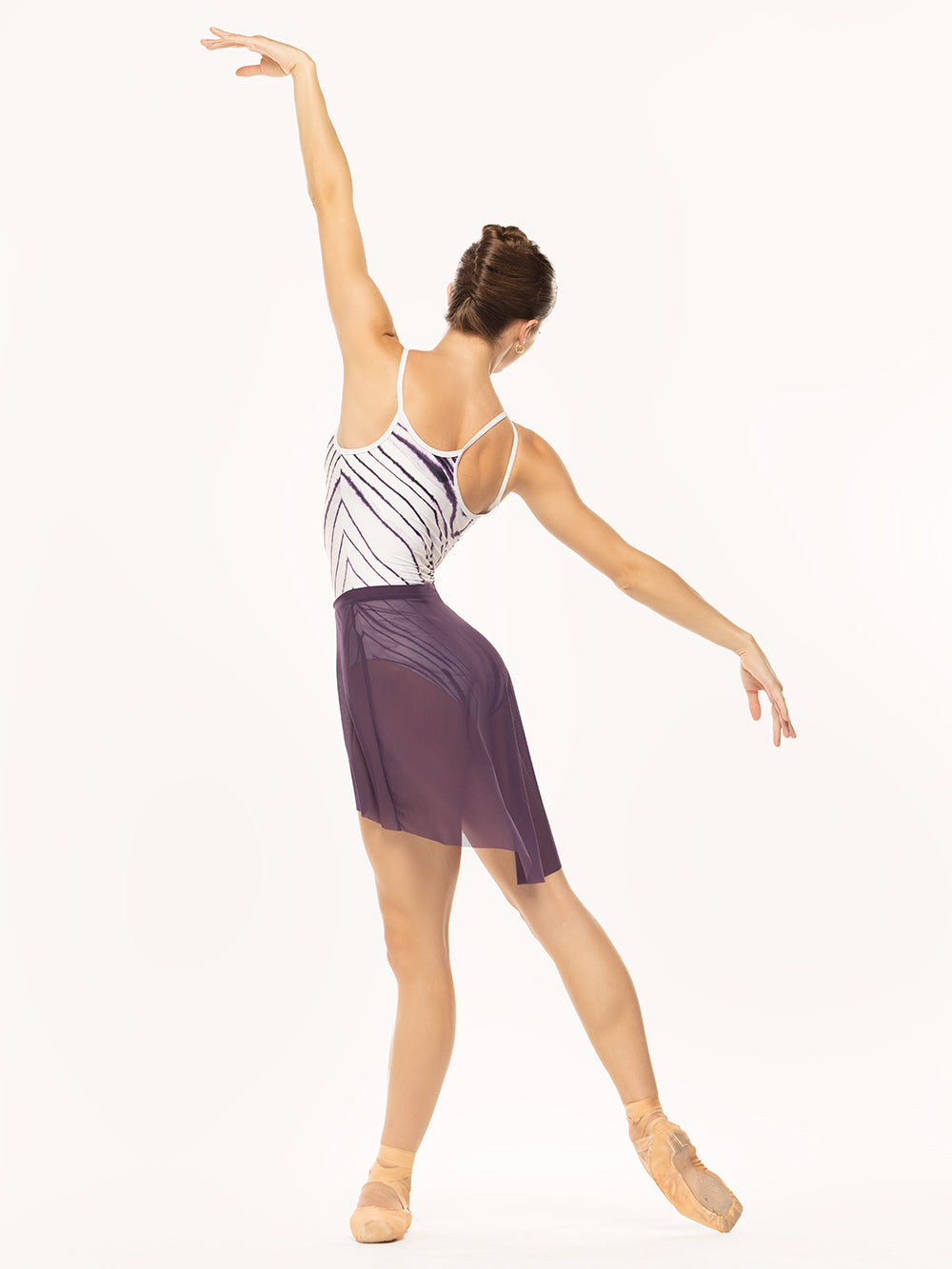 Eleve Dancewear Sundra Leotard in Striations print, back view of dance posing on tendu derriere.