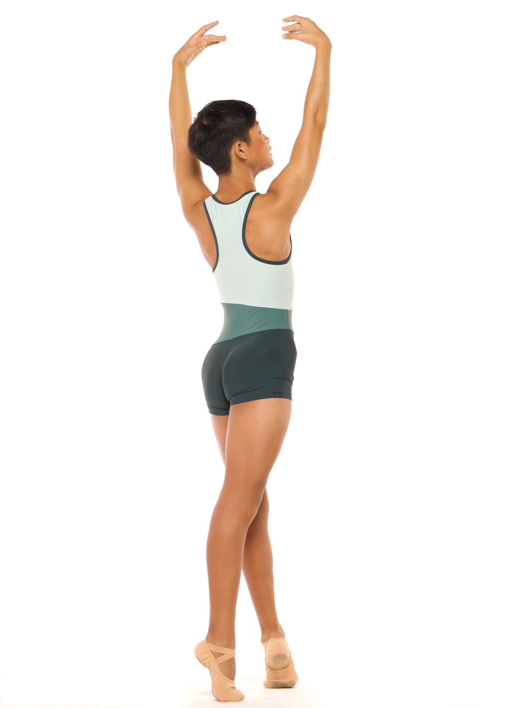 Eleve Dancewear Troy Biketard Kids in Dark Forest color, back view of dancer on four croise releve