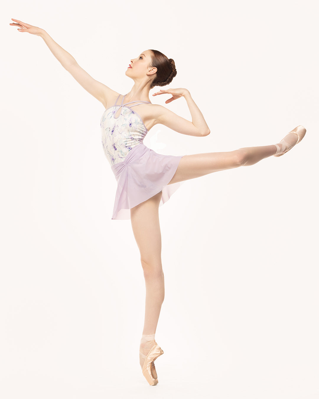 Eleve Dancewear Noelle Leotard in Wild Orchid print, front view of dancer on pique first arabesque.