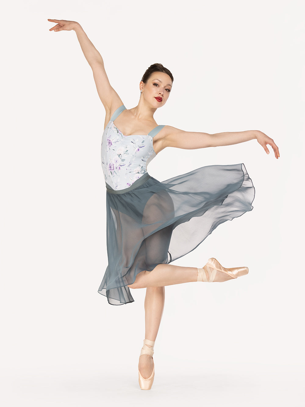 Eleve Dancewear Chiffon Rehearsal Skirt in Blue Agave print color, front view detail of dancer on pique crossed passe epaulement