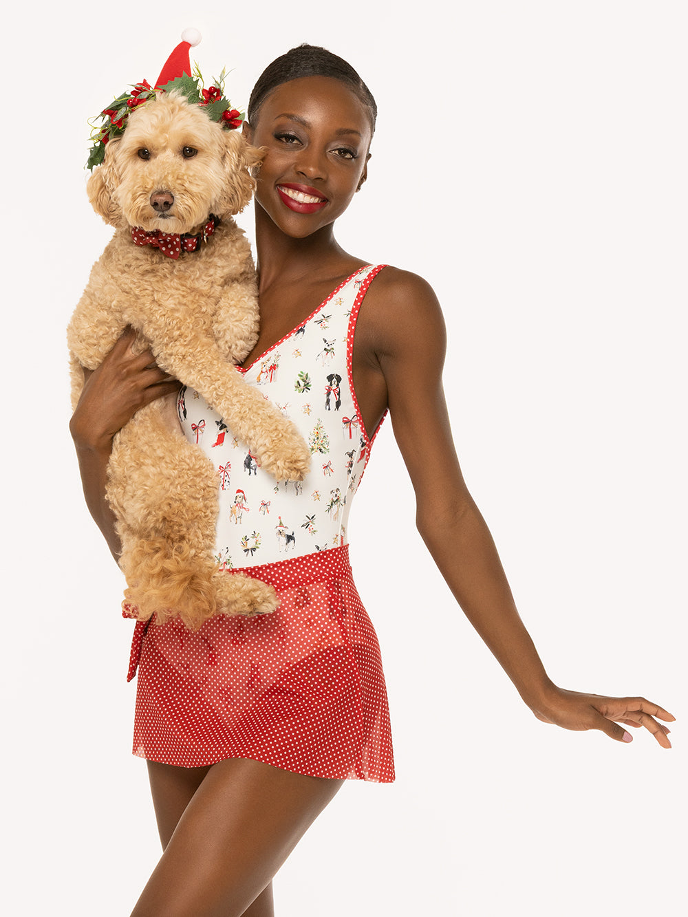 Eleve Dancewear Mini Tie Skirt in Red & White Dots Mesh print, front view of dancer posing with a cute doggy
