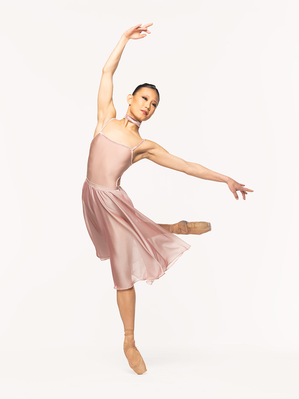 Eleve Dancewear Chiffon Rehearsal Skirt Kids in Dusty Rose print color, front view of dancer on pique attitude derriere croise epaulement