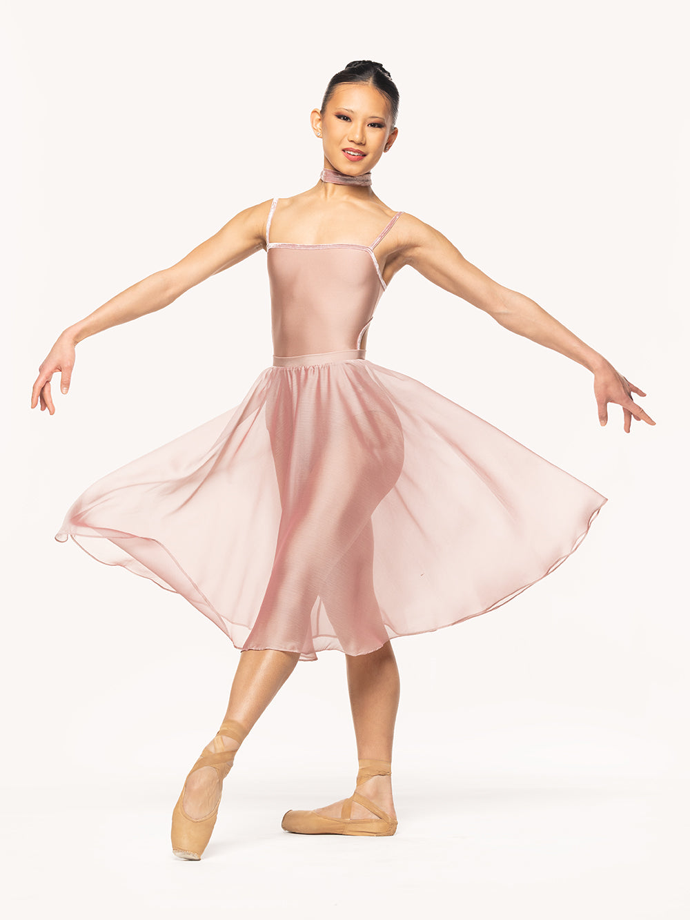 Eleve Dancewear Choker in Dusty Rose Crushed Velvet print color fabric, front view of dancer on tendu devant croise