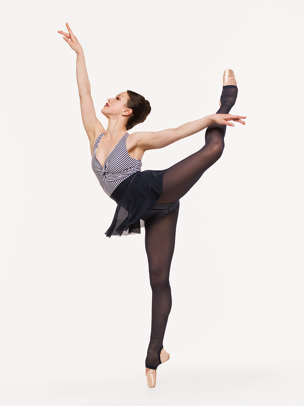 Eleve Dancewear Hipster Skirt in Eclipse Mesh color, profile view of dancer on pique attitude efface