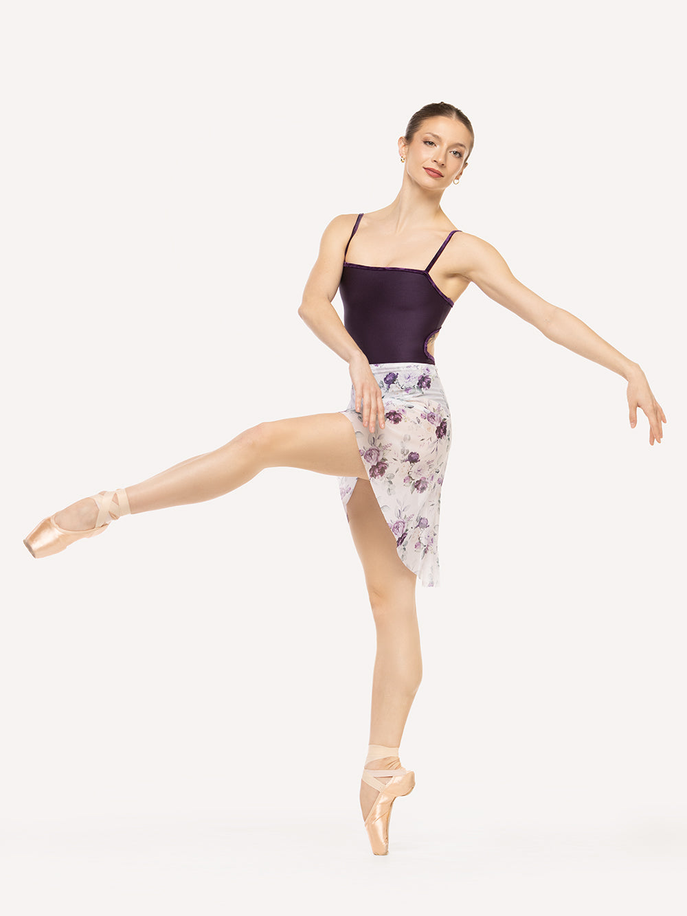 Eleve Dancewear Vienna Mid High-Low Wrap Skirt in Moonlit Garden Mesh print color, front view of dancer on pique attitude devant croise