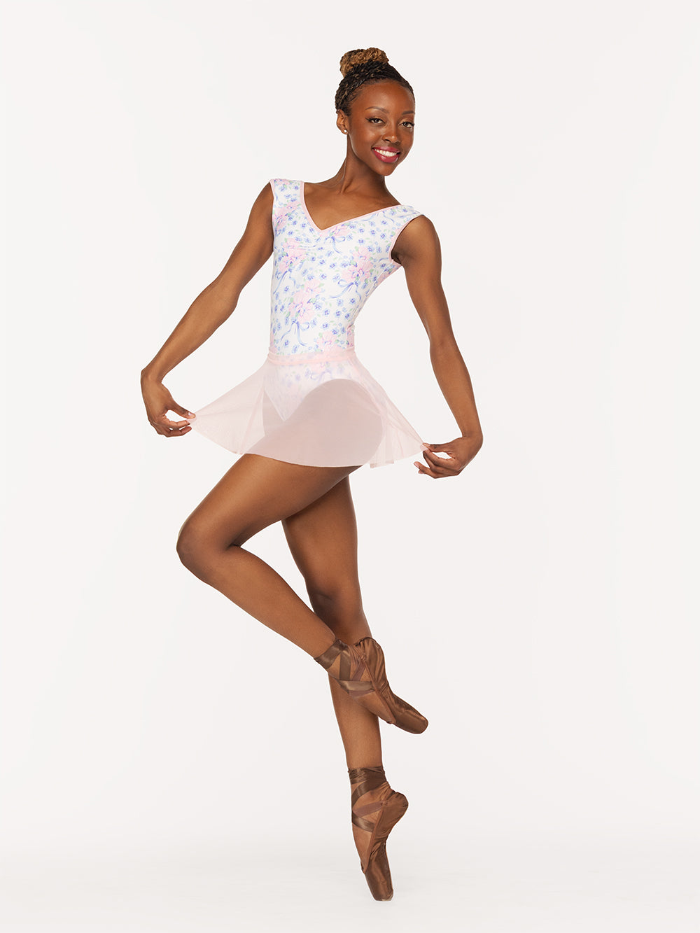 Eleve Dancewear Flare Skirt in Light Pink Mesh color, front view of dancer on pique cou-de-pie en dedans