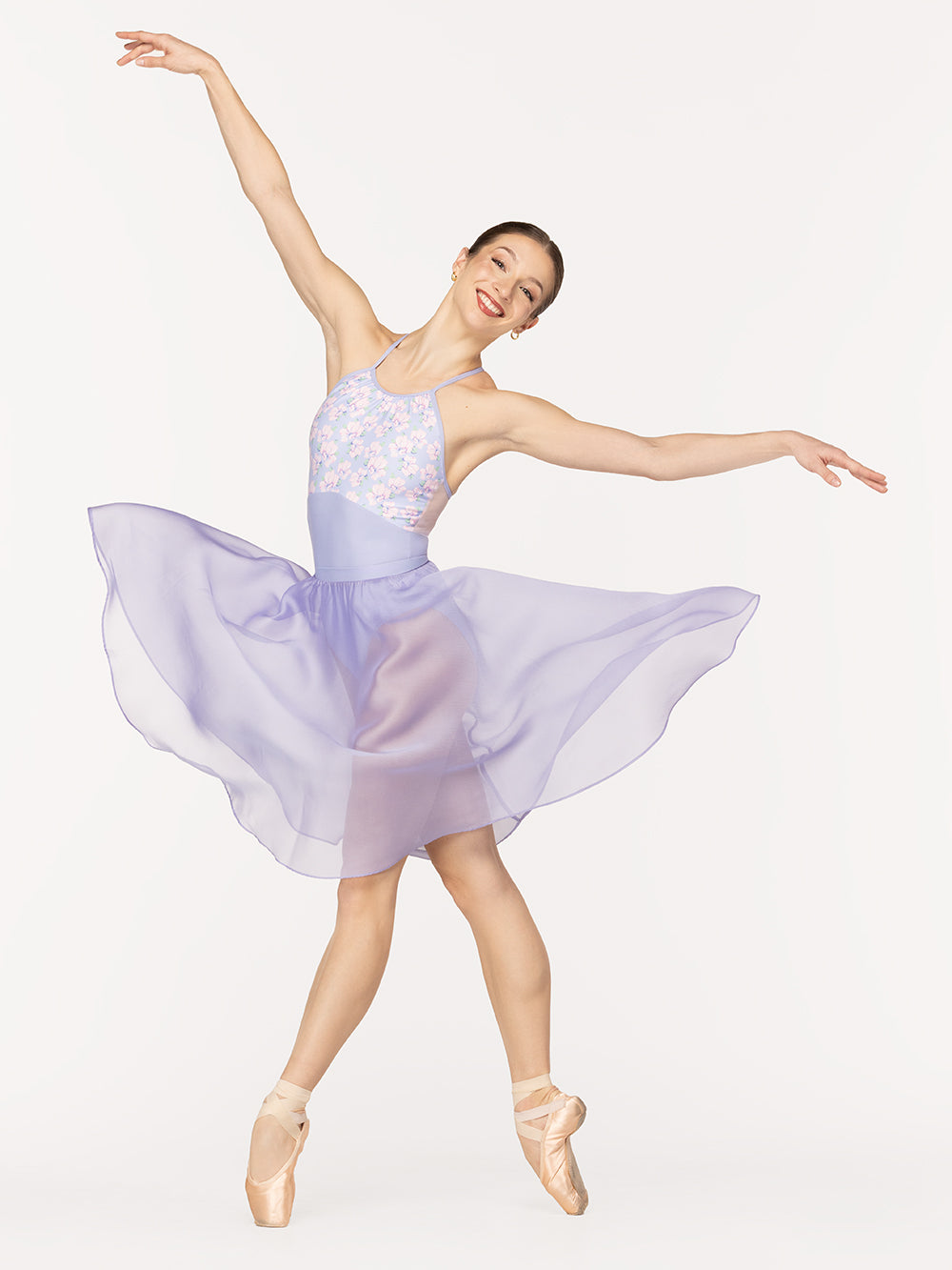 Eleve Dancewear Ebony Leotard in Flower Toss print, front view of dancer on pointe four croise