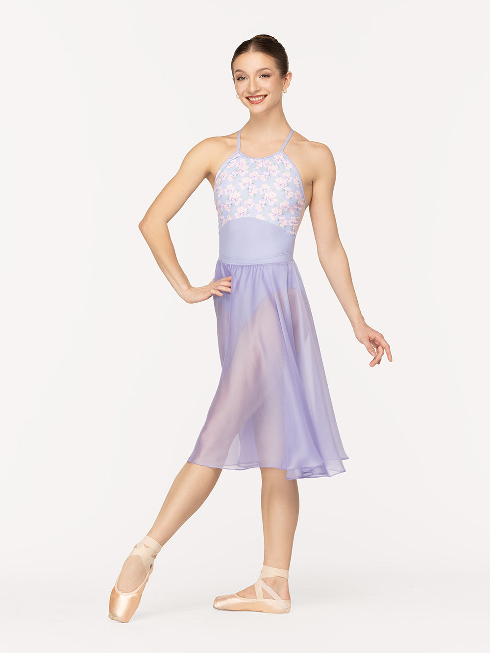 Eleve Dancewear Ebony Leotard Kids in Flower Toss print, front view of dancer on tendu devant