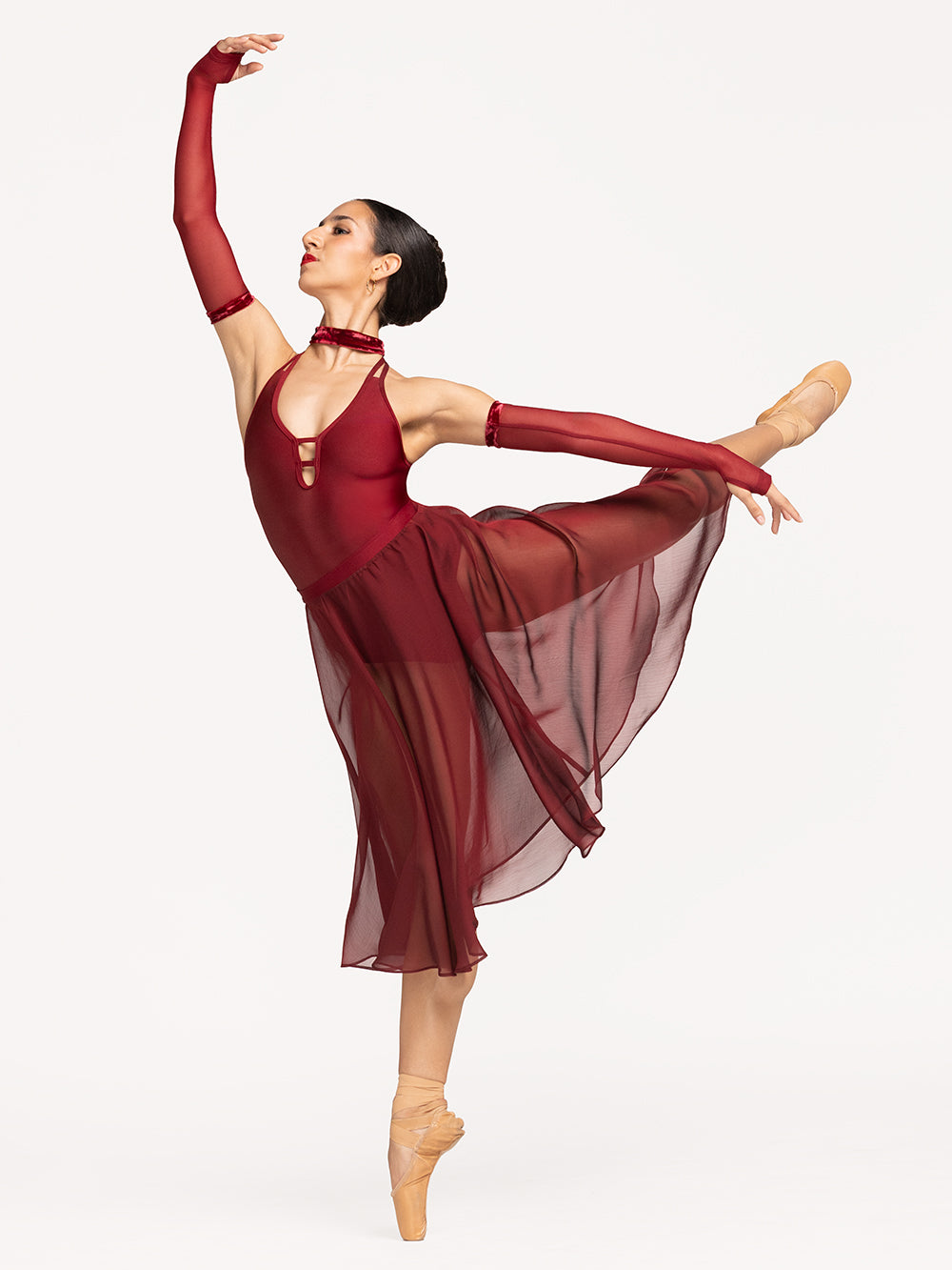 Eleve Dancewear Arm Sleeves in Garnet Mesh print color, front view of dancer on pique attitude efface