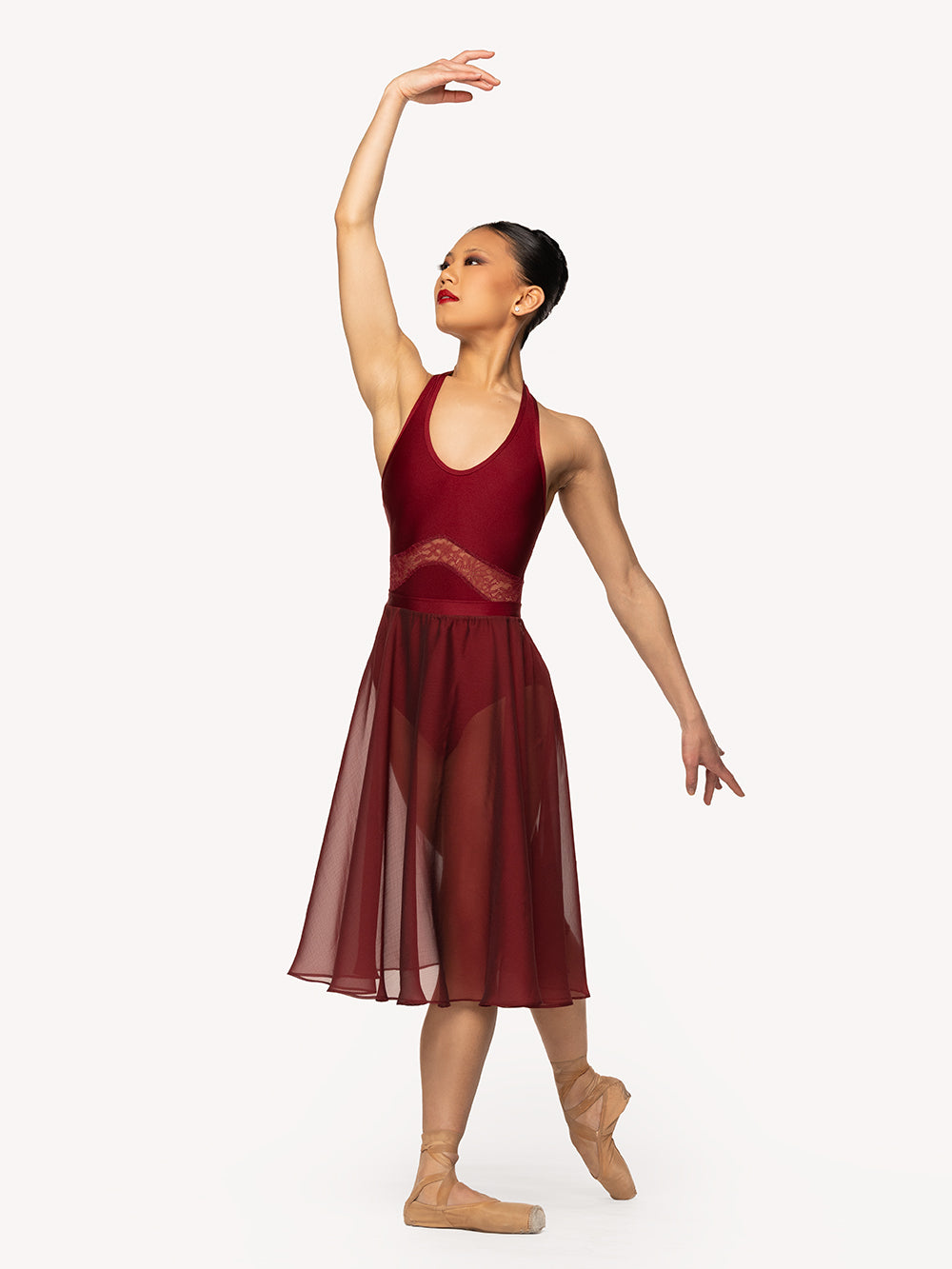 Eleve Dancewear Miyesha Leotard Kids in Garnet print color, front view of dancer on tendu derriere croise