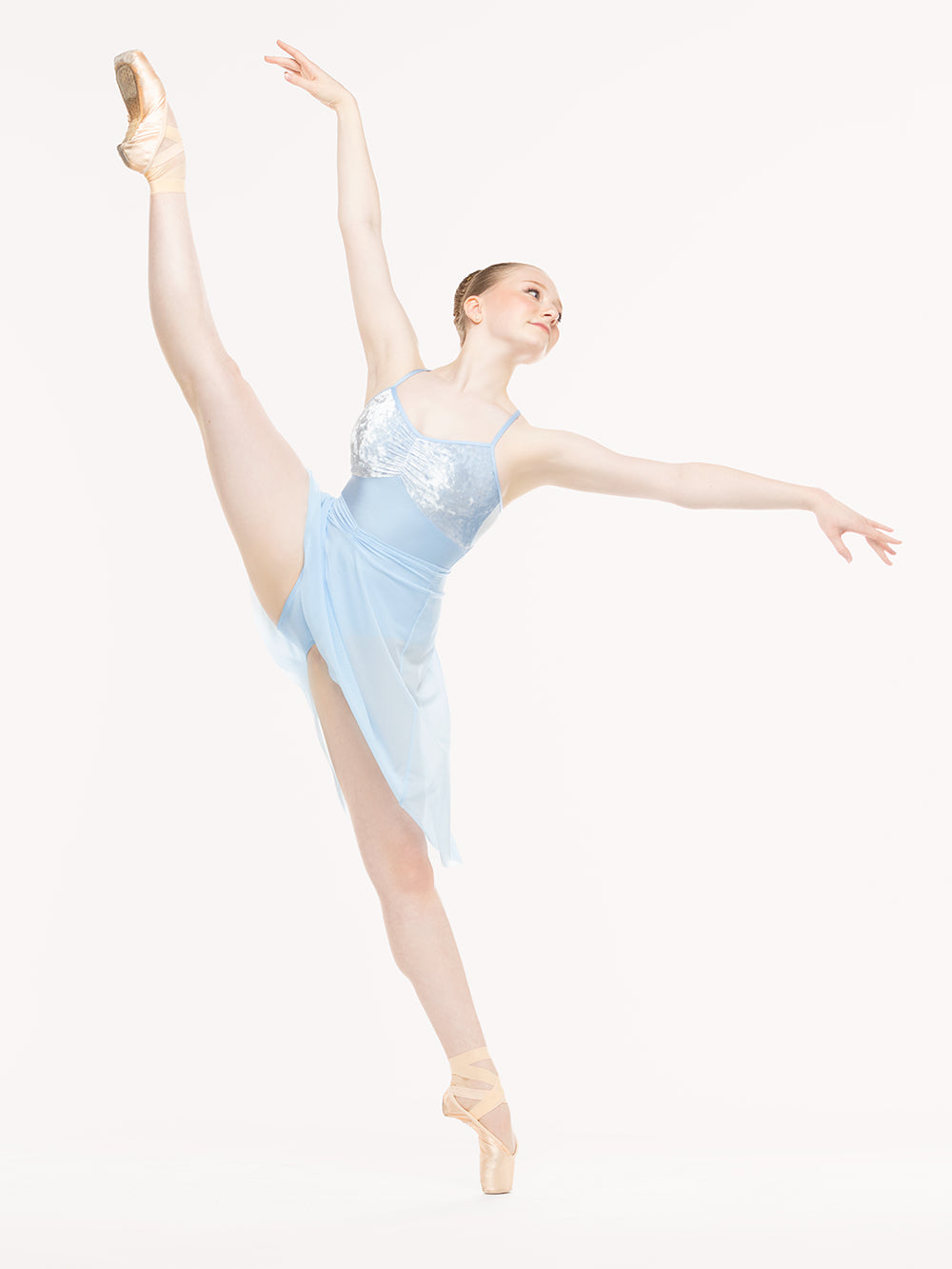 Eleve Dancewear Amora Long High-Low Skirt in True Blue color, front view of dancer on pique high a la seconde
