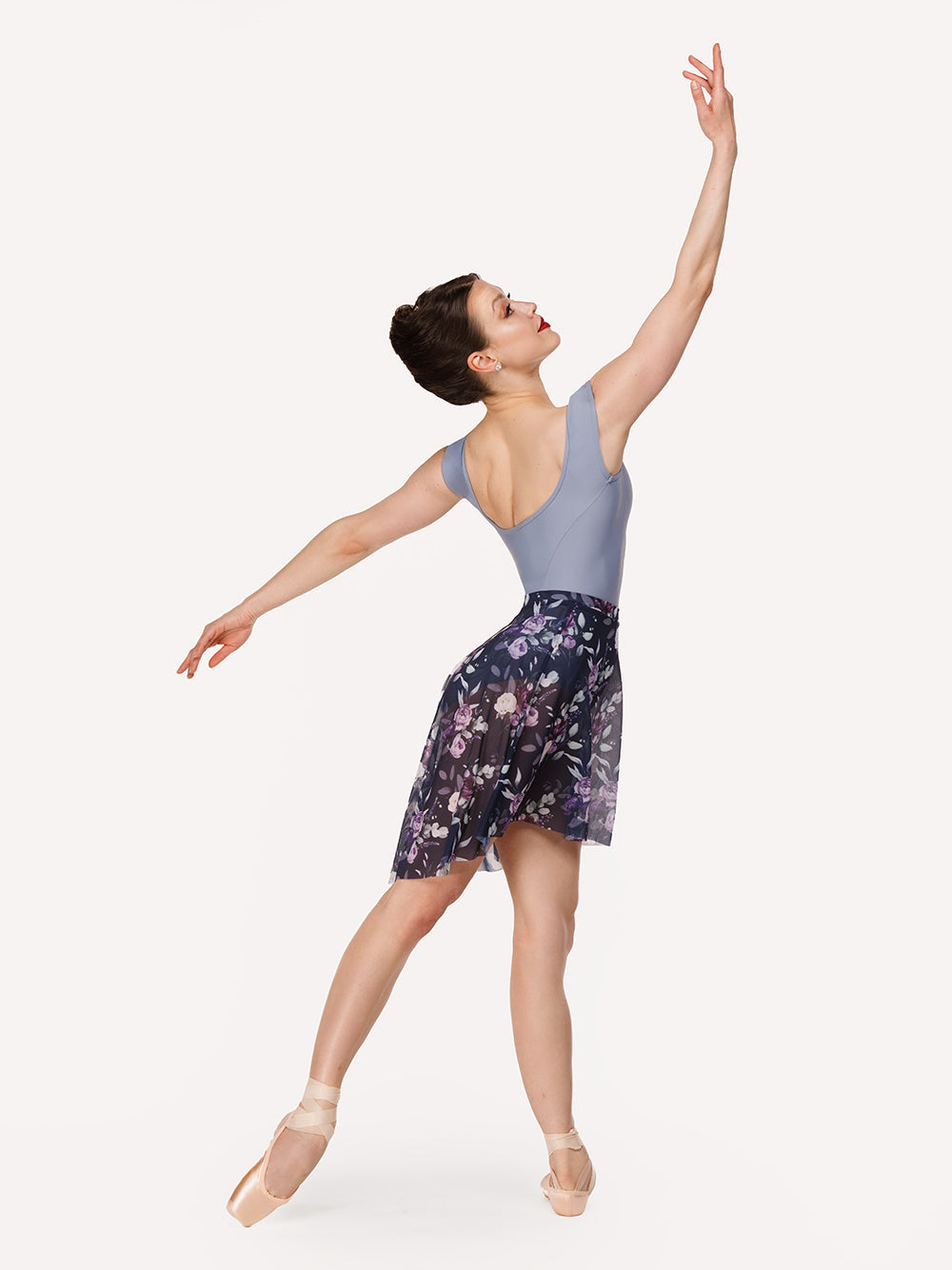 Eleve Dancewear Back Tuck Skirt in Moonlit Garden Eclipse Mesh print color, front view of dancer on tendu derriere efface