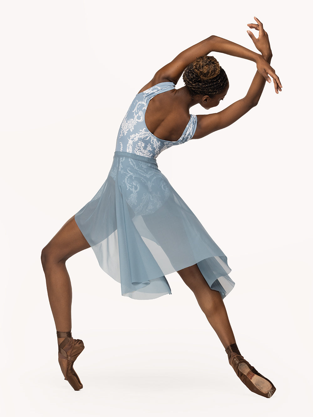 Eleve Dancewear Dragonfly Short Skirt Kids in Light Jean Mesh print color, back view of dancer on long four on point