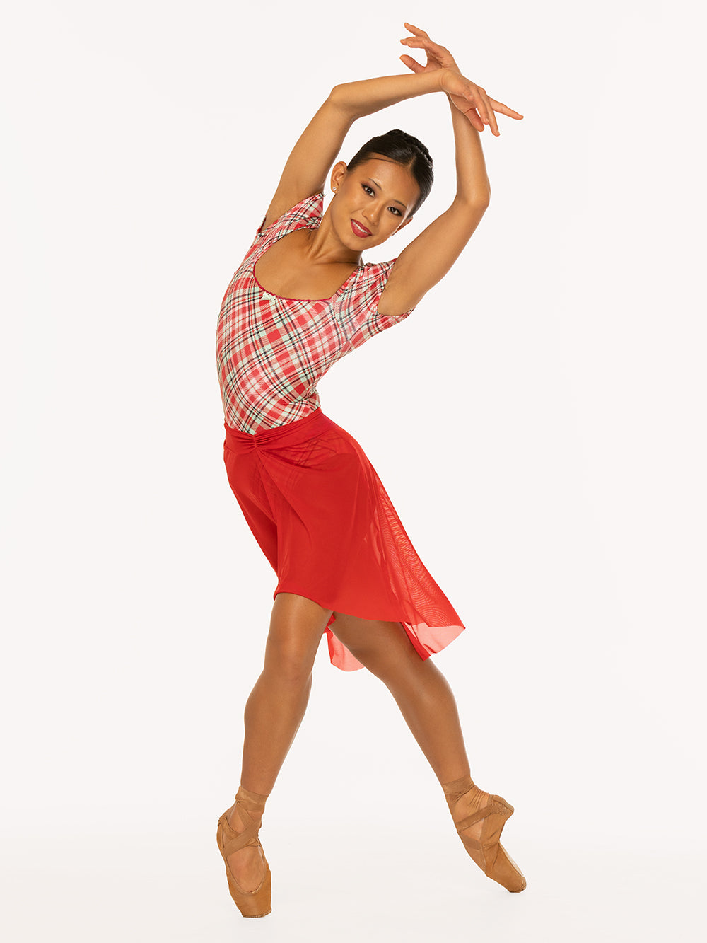Eleve Dancewear Xena Leotard Kids in Pink & Red Plaid print and Amora Long High-Low Skirt Kids in Red Mesh color, front view of dancer on pointe long four
