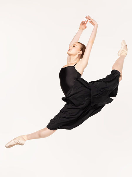 Eleve Dancewear Character Skirt in Black color, front view of dancer on sissonne saute.