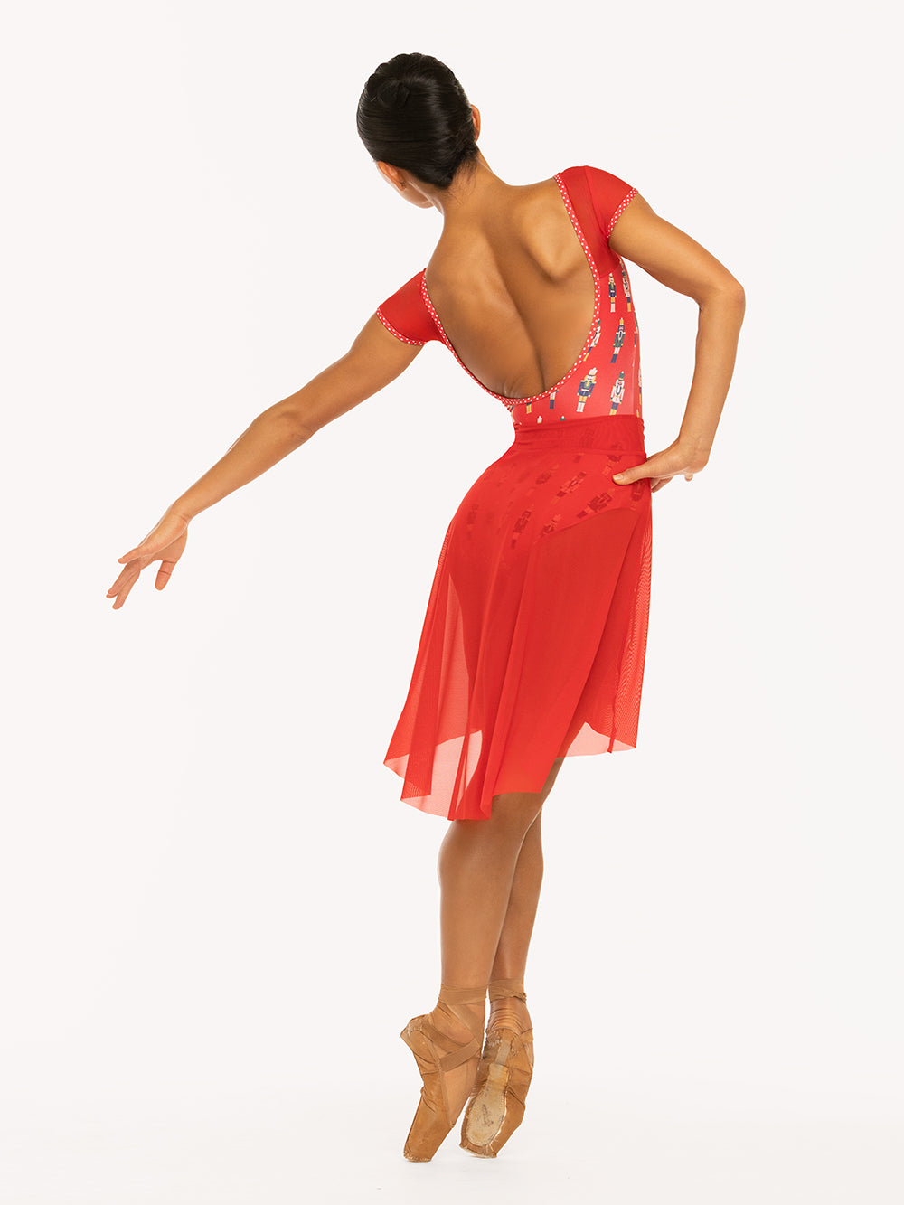 Eleve Dancewear Ida leotard in More Nuts Red print, back view of dancer on pointe leaning fifth