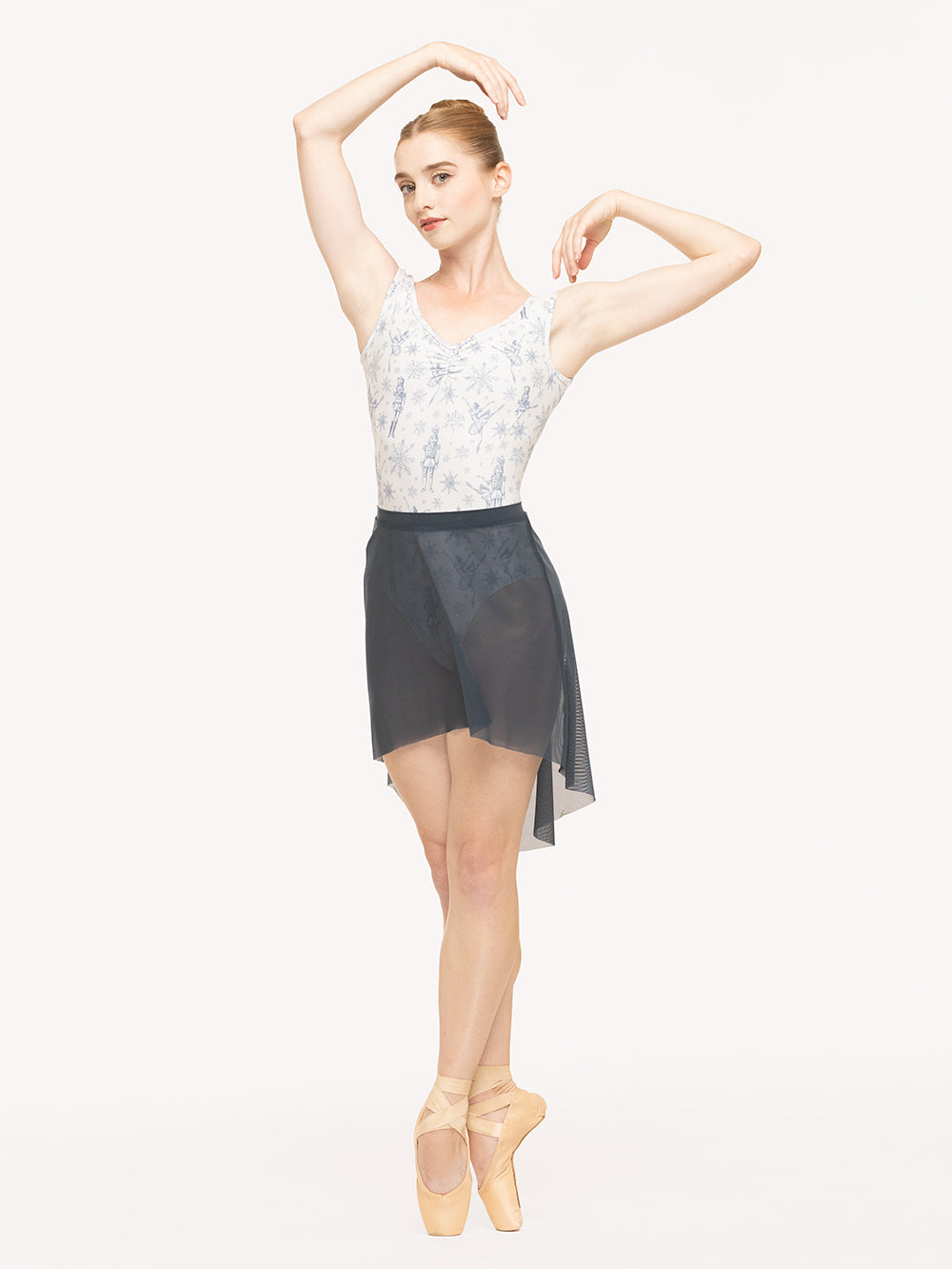 Eleve Dancewear Heather Leotard Kids in  Snow Scene print, front view of dancer on pointe fifth position