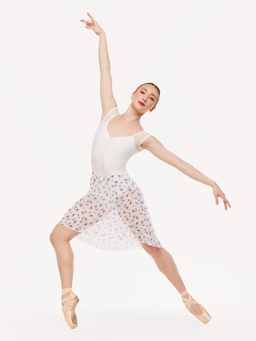 Eleve Dancewear Amora Long High-Low Skirt in Pathway Mesh print, front view of dancer on point four efface epaulement