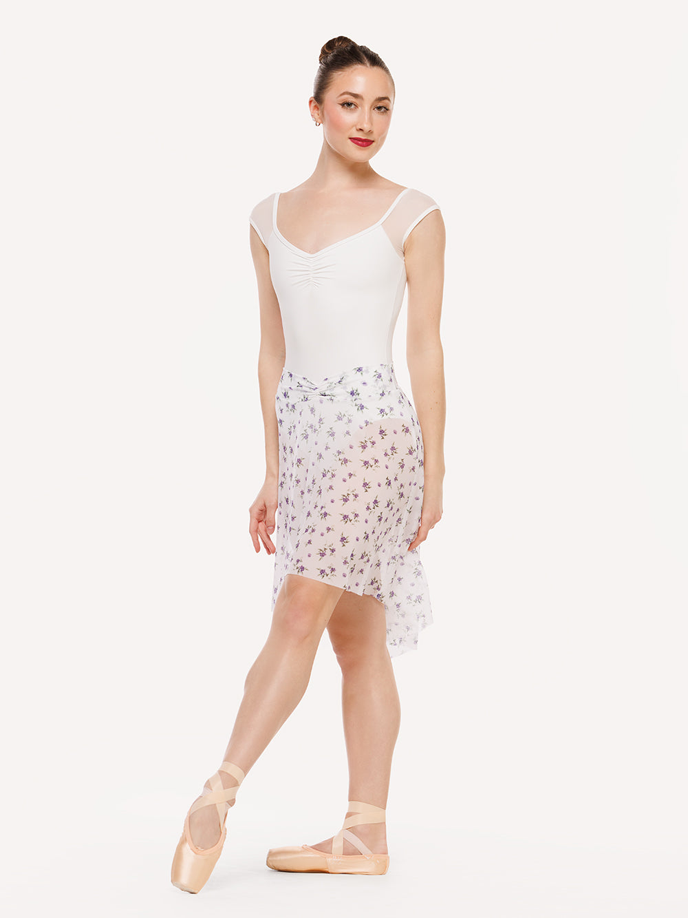 Eleve Dancewear Amora Long High-Low Skirt in Pathway Mesh print, front view of dancer on tendu devant croise