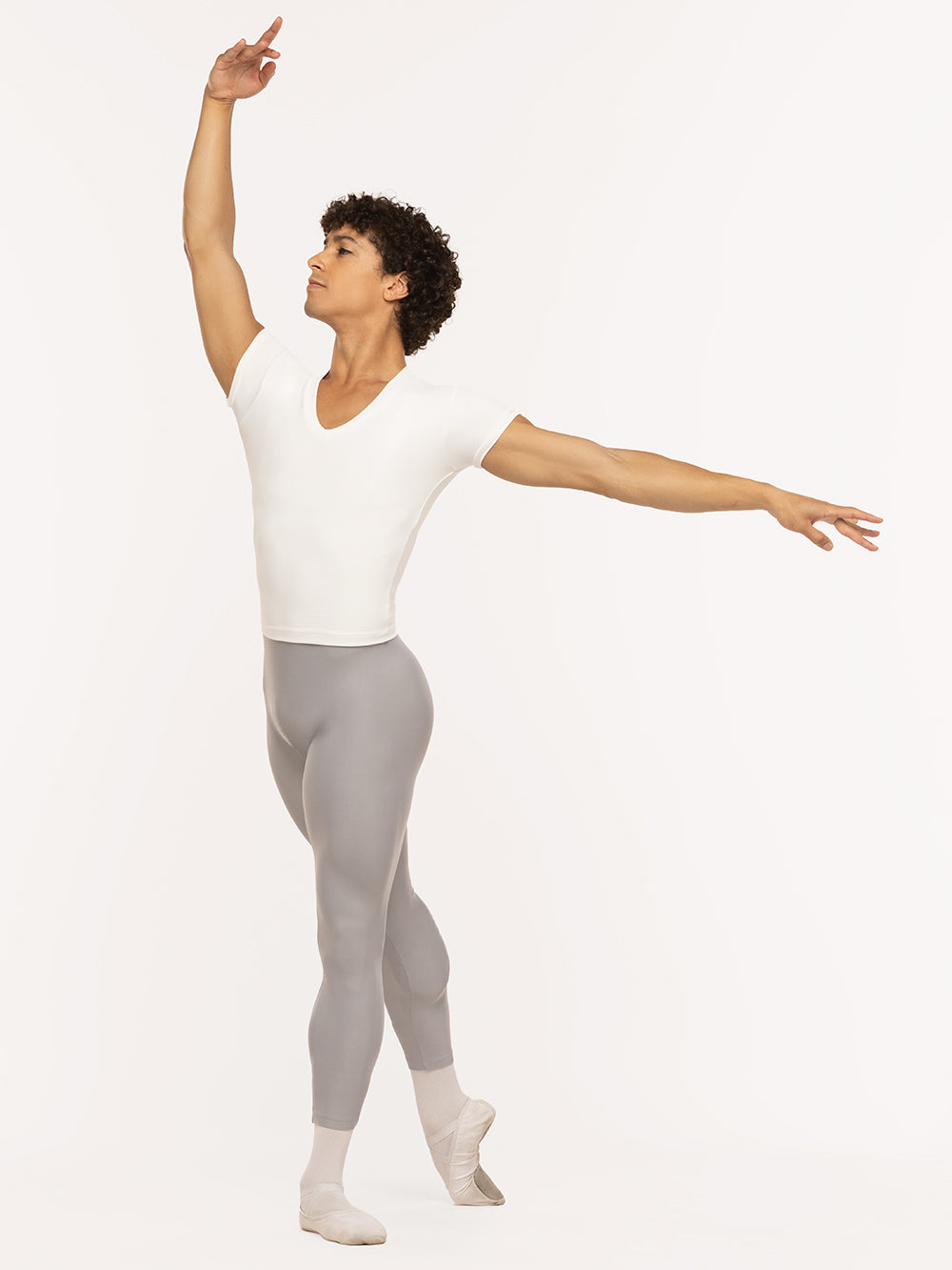 Eleve Dancewear John Shirt in Stage White color, front view of dancer on tendu derriere crosie