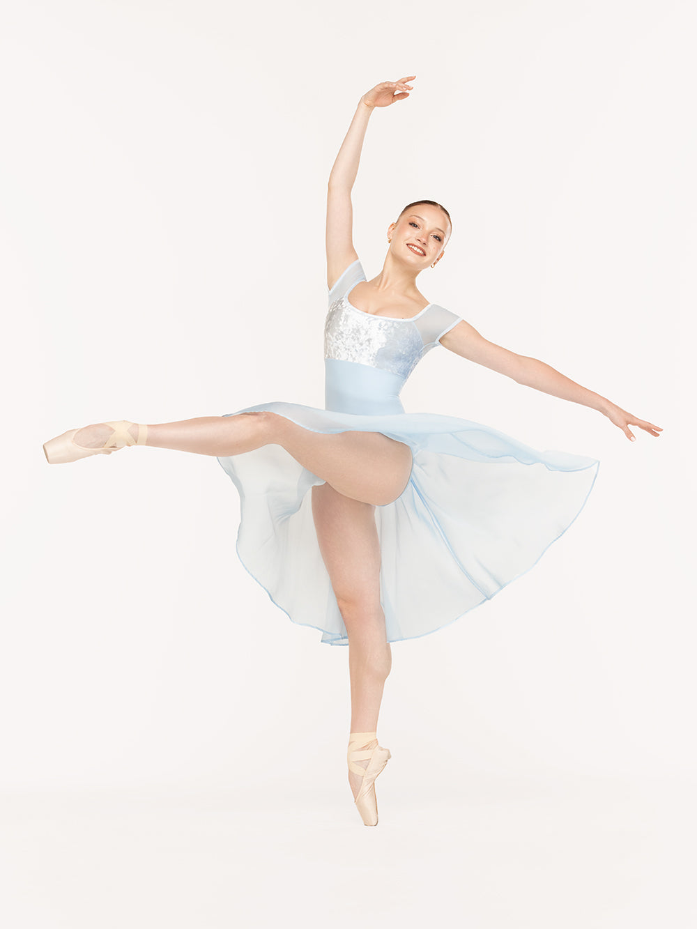 Eleve Dancewear Jane Leotard in True Blue color, front view of dancer on pique attitude devant croise
