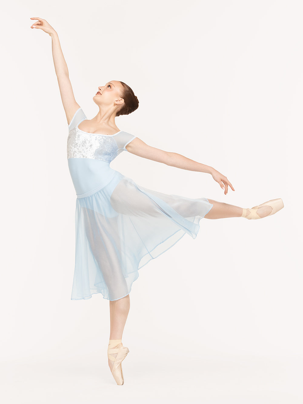 Eleve Dancewear Jane Leotard Kids in True Blue color, front view of dancer on pique first arabesque